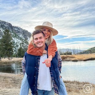 A woman showing off her engagement ring while hugging her fiance