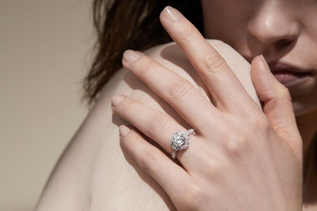 A woman wearing a diamond engagement ring