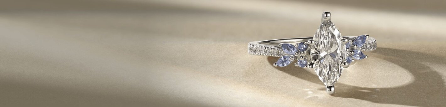 A diamond engagement ring with a marquise shaped center diamond