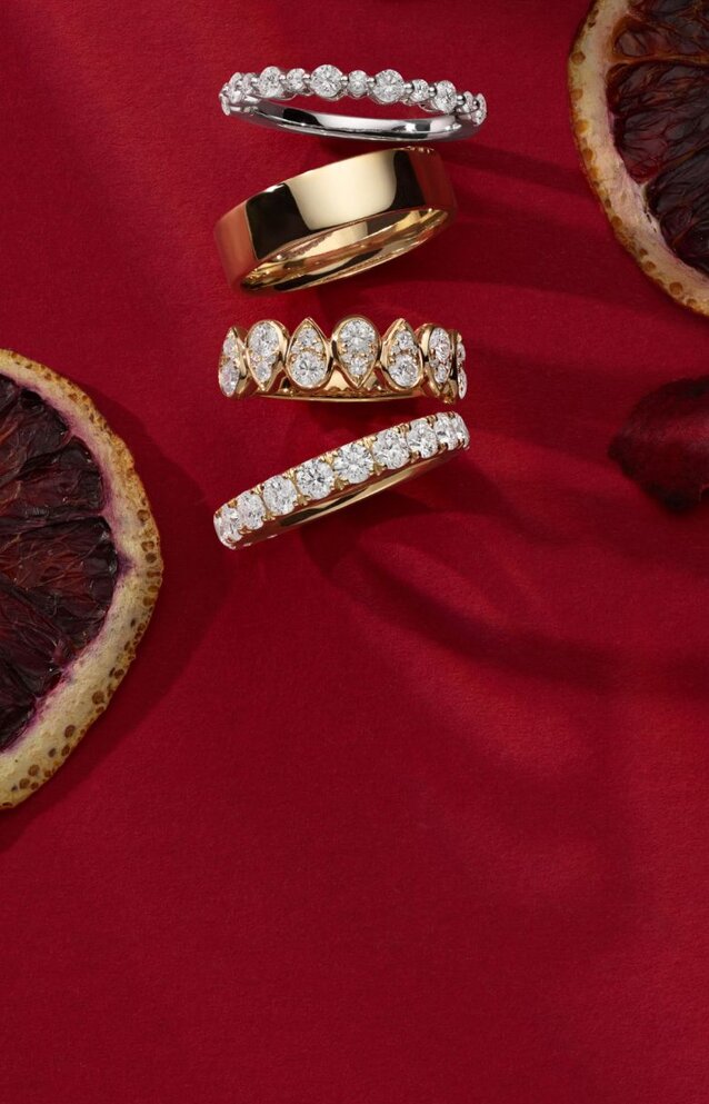 Four wedding bands on a red background