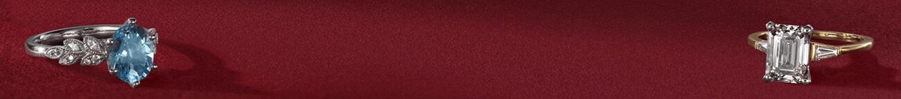 Two engagement rings on a festive red background