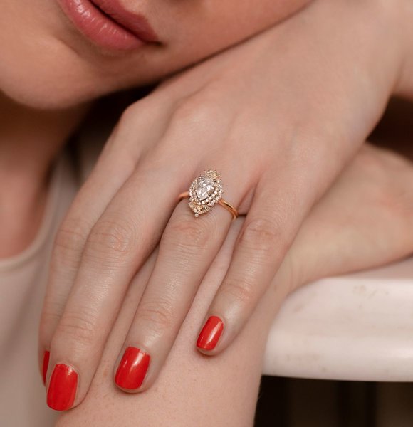 Pear shaped diamond and gold engagement ring