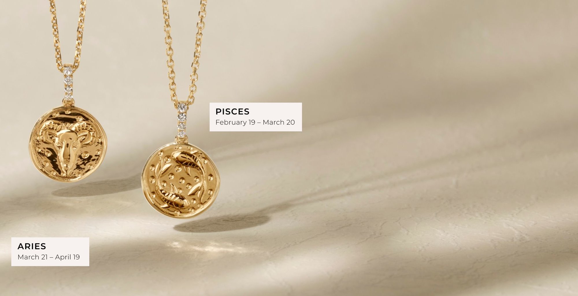 An Aries and a Pisces zodiac pendant