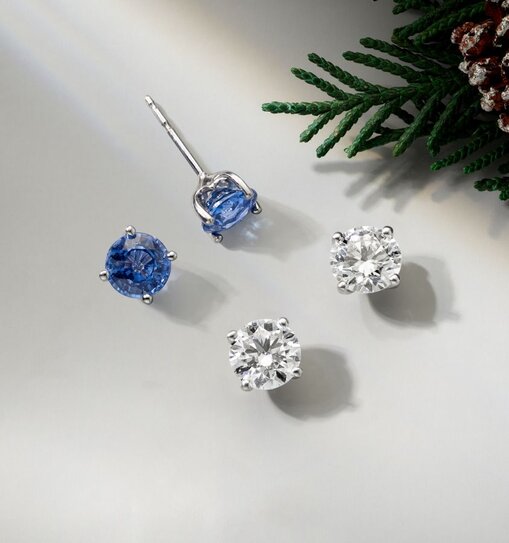 A pair of diamond stud earrings and a pair of sapphire stud earrings