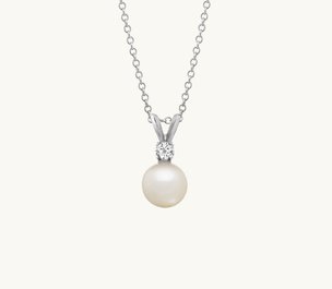 A freshwater pearl and diamond pendant in white gold