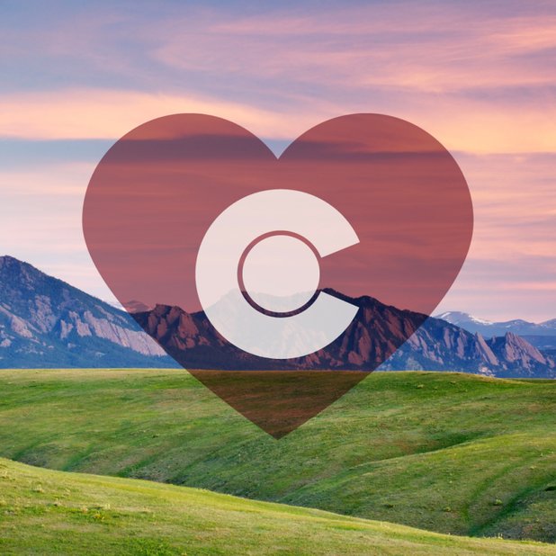 A heart with the letter C inside it on a mountain backdrop
