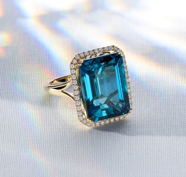 a gold ring with topaz center stone