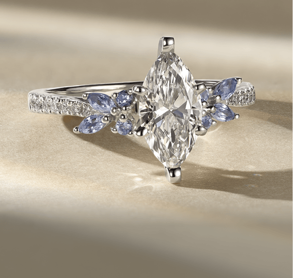 A diamond engagement ring with a marquise shaped center diamond