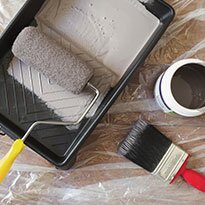 Painting supplies on a clear drop sheet.