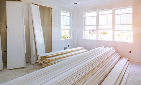A room under construction with building materials piled up.