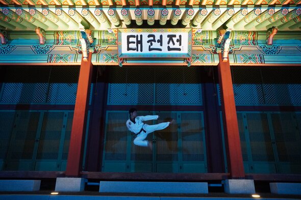 Group of new black belts celebrating their achievements at a promotion ceremony