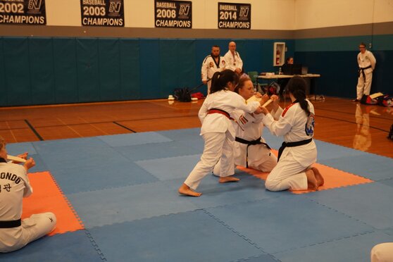 A student is breaking a board at a tournament