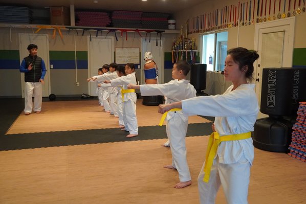 Row of beginner students practicing their punches