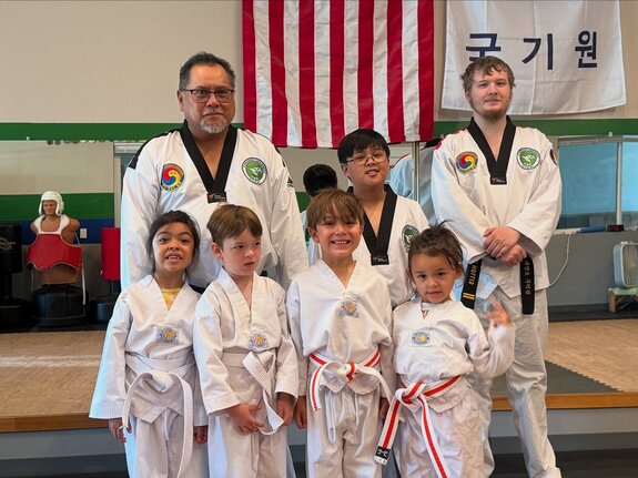 Pre-K aged students practicing their punches with an instructor
