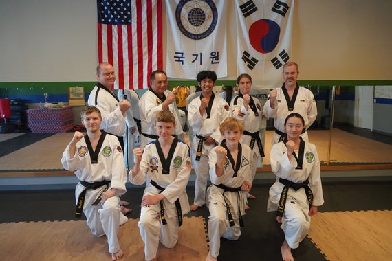 Group of Black Belt Instructors celebrating a successful workout completed