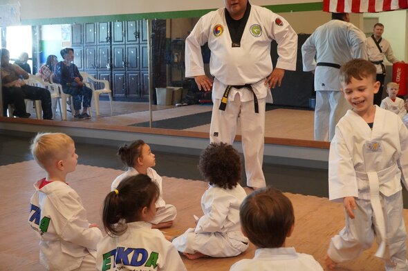 Pre-K aged students practicing their punches with an instructor