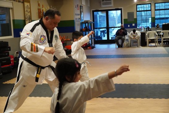 Pre-K aged students practicing their punches with an instructor