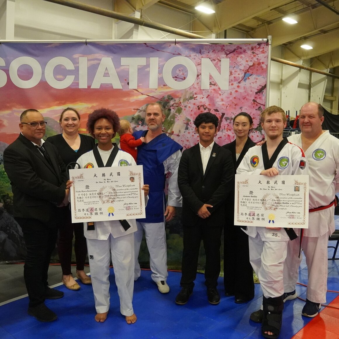 Our staff celebrating two recent black belt promotions