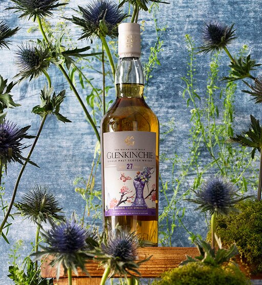 A bottle of Glenkinchie 27 Year Old (Special Release 2023) surrounded by thistles. 