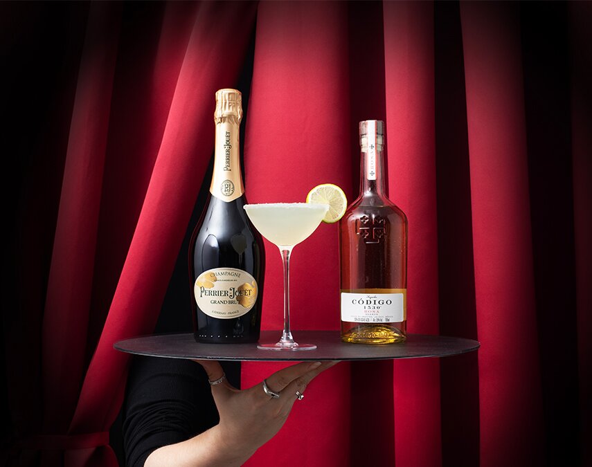 A bottle of Perrier-Jouët Grand Brut and Código 1530 Rosa with a champagne margarita cocktail.