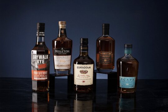 Five bottles of whisky - The Macallan, Redbreast, The Glenlivet, Sagamore, and Bunnahabhain 