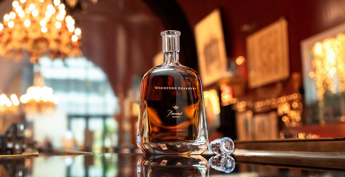 A bottle of Woodford Reserve Baccarat on a bar.