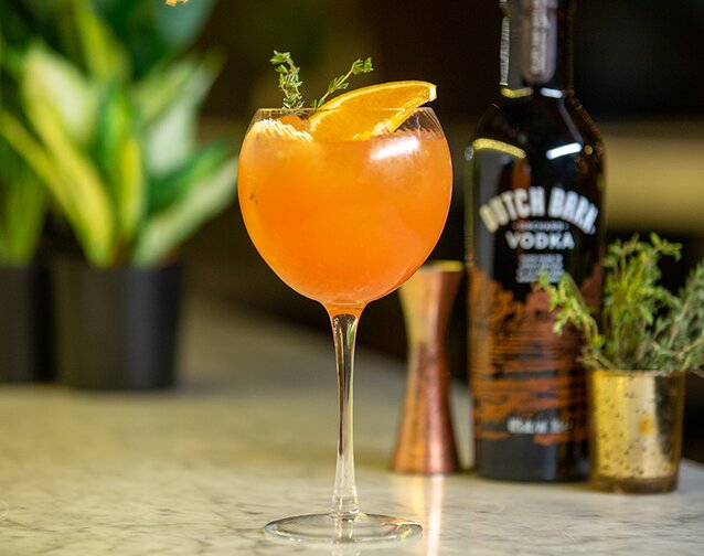 A cocktail serve with a bottle of Dutch Barn Vodka.
