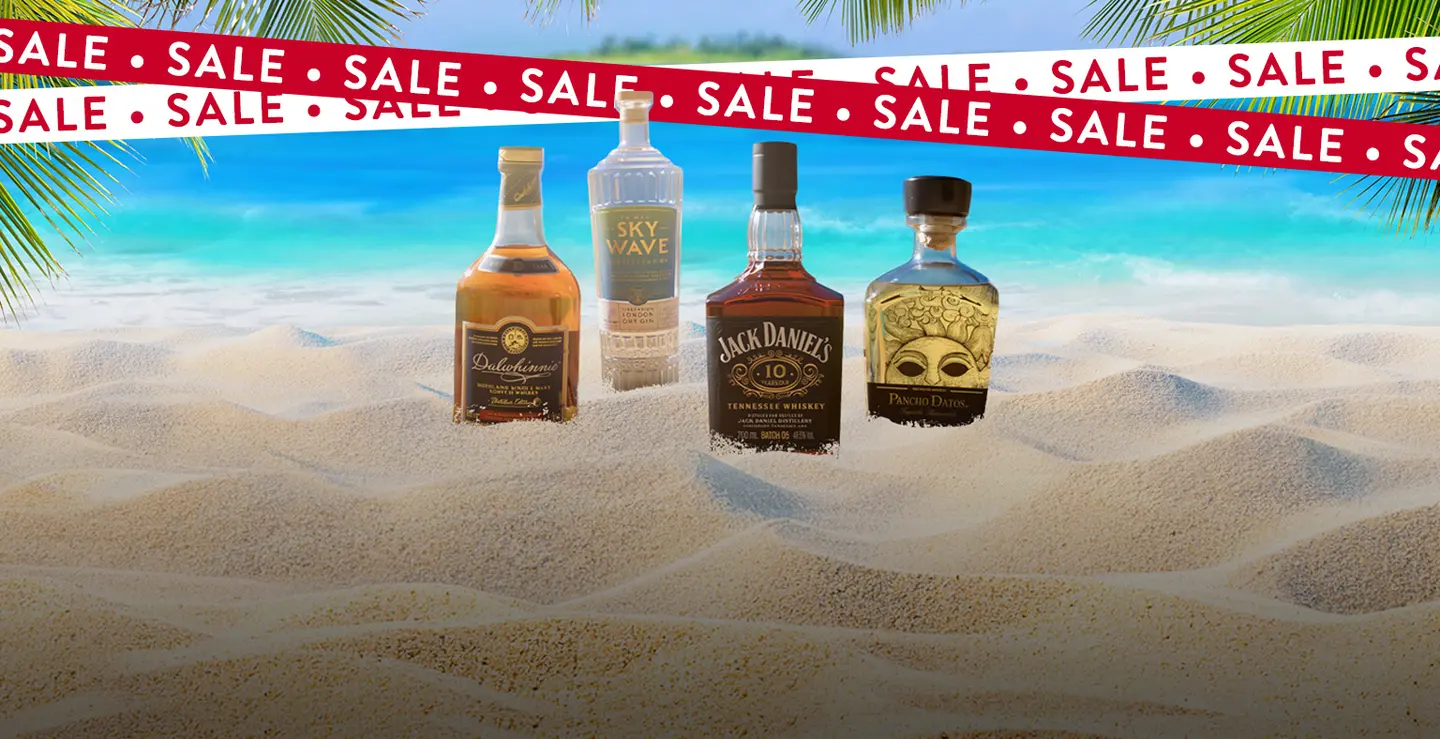 Four bottles of spirit on a white snad beach with SALE banners over the top. 