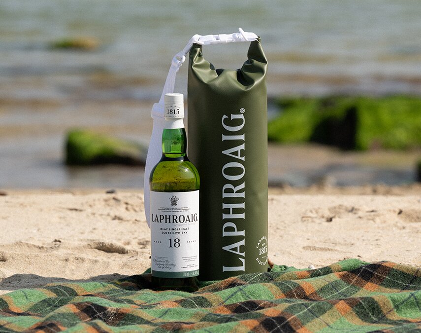 A bottle of Laphroaig 18 year old and Laphroaig branded dry bag 