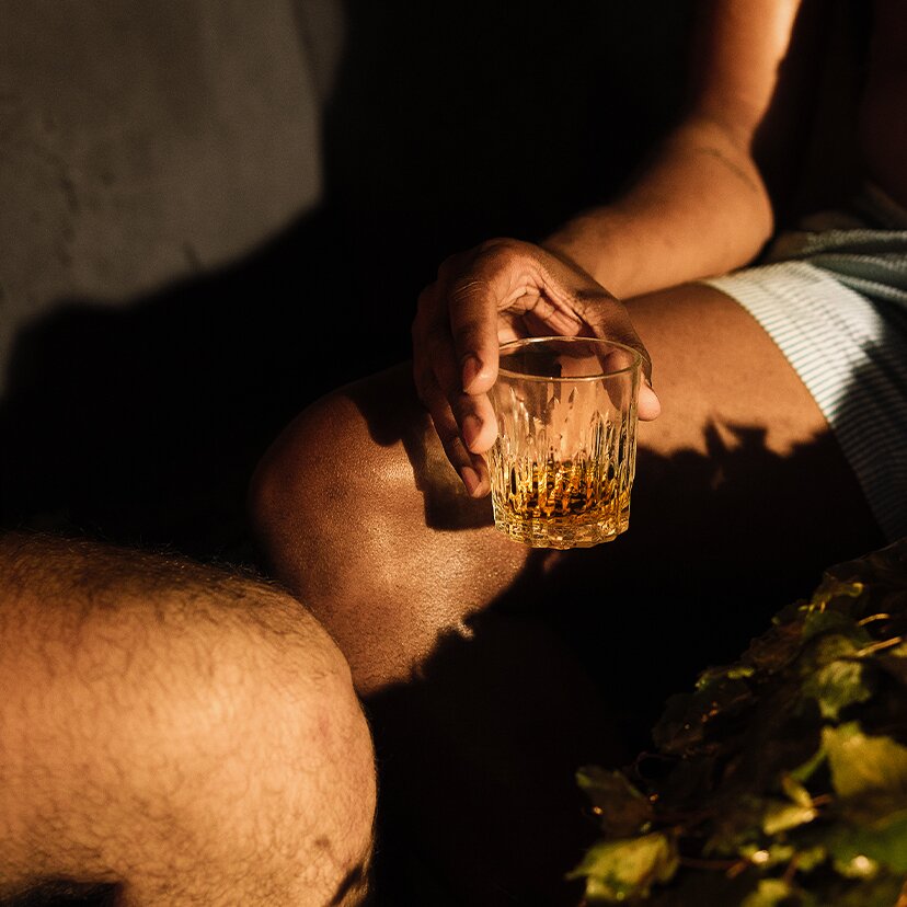 A glass of Kyrö Sauna Stories No.2 in a sauna.