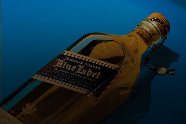 A bottle of Johnnie Walker Blue Label on a blue backdrop.