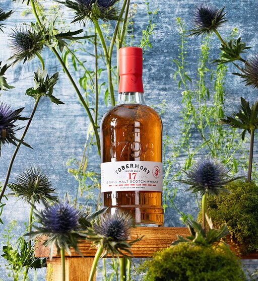 A bottle of Tobermory 17 Year Old 2004 Oloroso Cask surrounded by thistles.