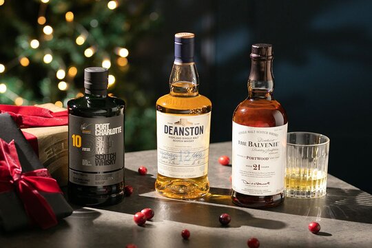 Three bottles of Scotch whisky in a Christmas setting