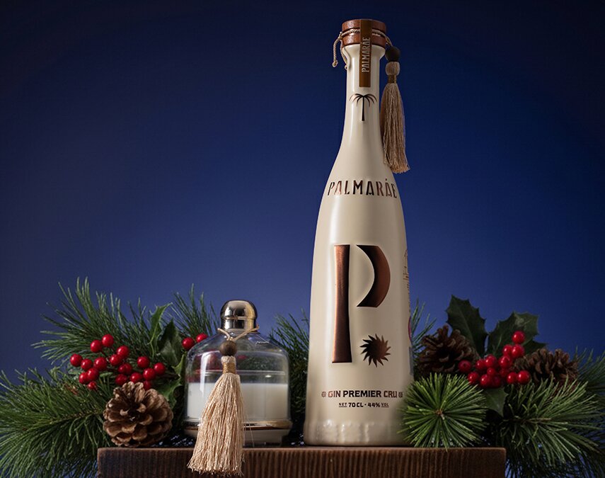 A bottle of Palmaráe Gin Premier Cru with a branded candle