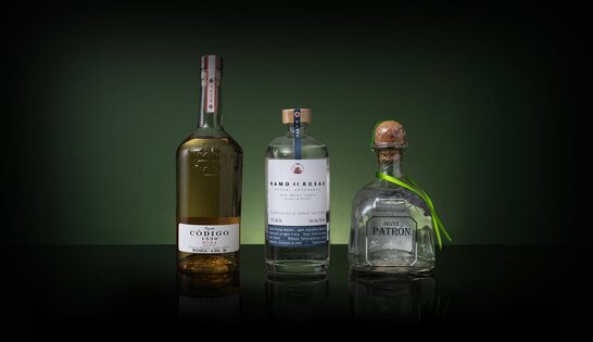 3 bottles of Tequila on a bokeh blurred background