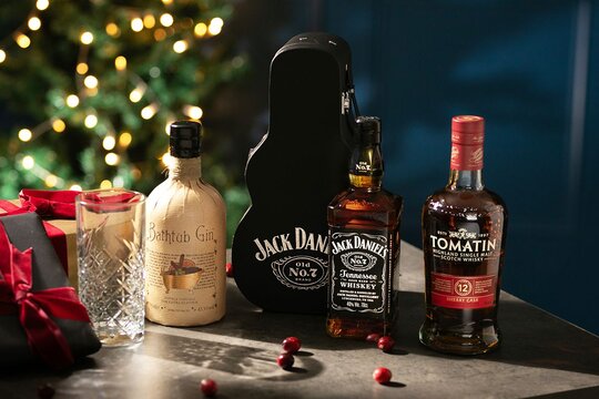 A old-fashioned whisky gift, gin gift with candle and glasses on a Christmas setting