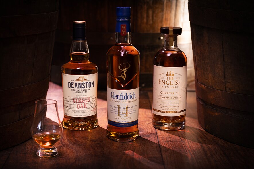 Three bottles of wine cask finished whisky from Deanston, Glenfiddich and The English.