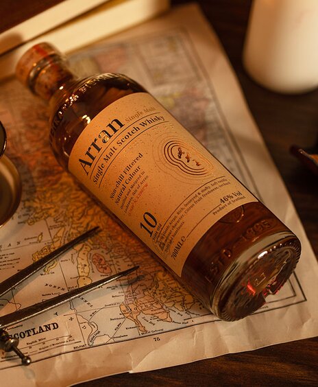 A bottle of Arran 10 year old on top of a map of Scotland. 