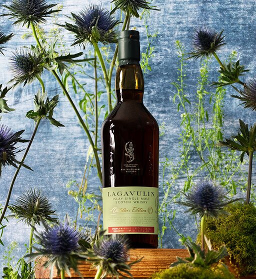 A bottle of Lagavulin Distillers Edition - 2022 Collection surrounded by thistles.