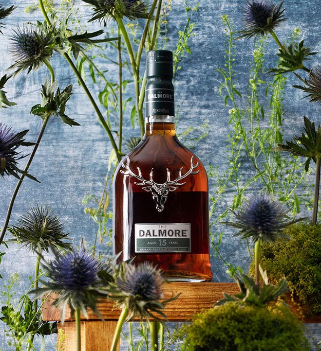 A bottle of Dalmore 15 year old surrounded by thistles. 