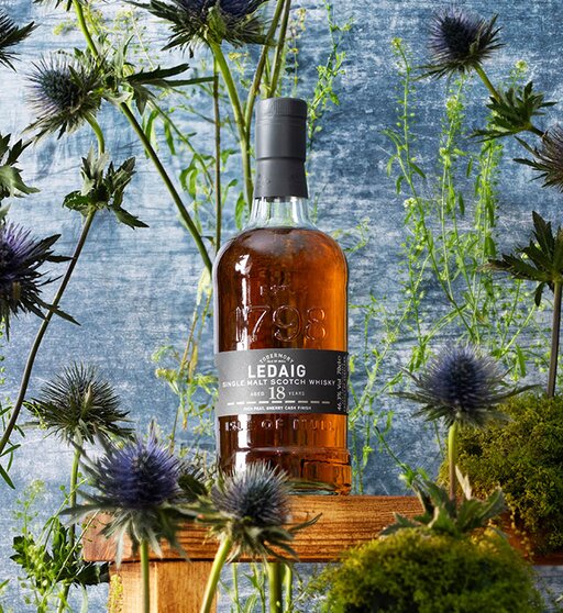 A bottle of Ledaig 18 Year Old  surrounded by thistles.