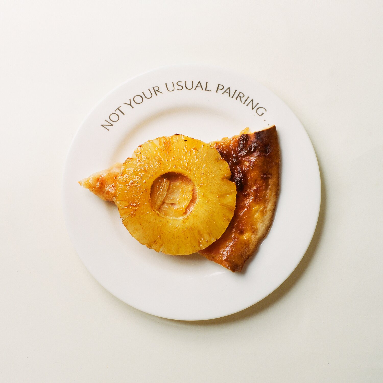 A plate with pineapple pizza.