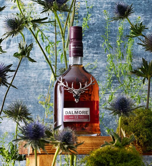 A bottle of Dalmore 12 year old surrounded by thistles. 