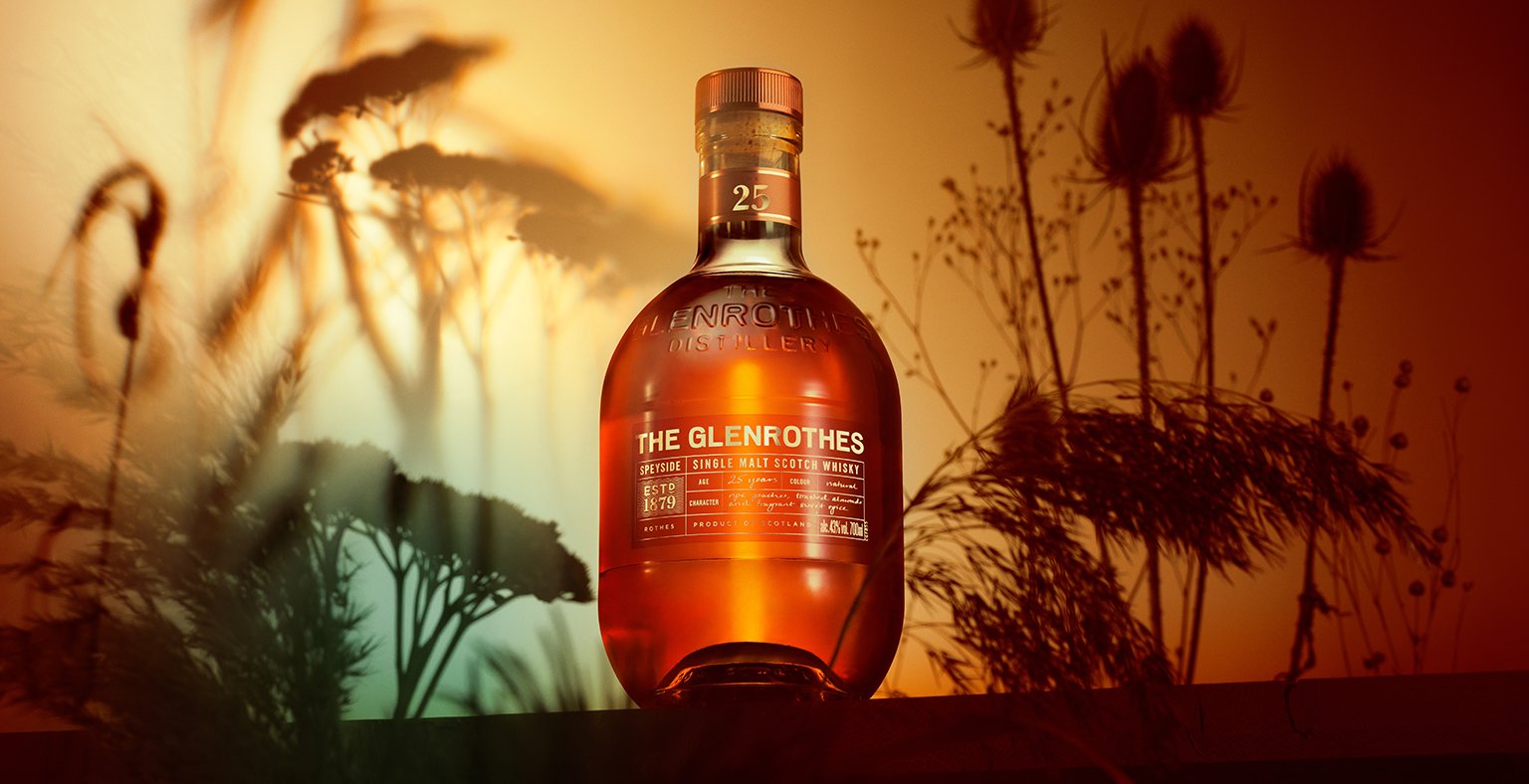 A bottle of The Glenrothes 25 Year Old with floral graphic background
