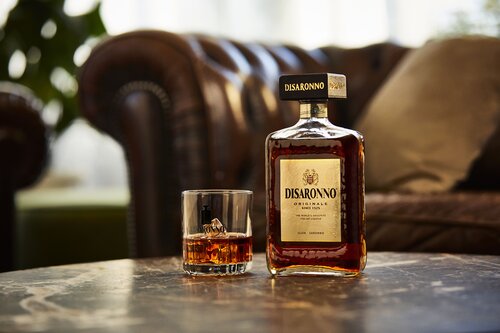 Bottle of Disaronno with a glass on the rocks.
