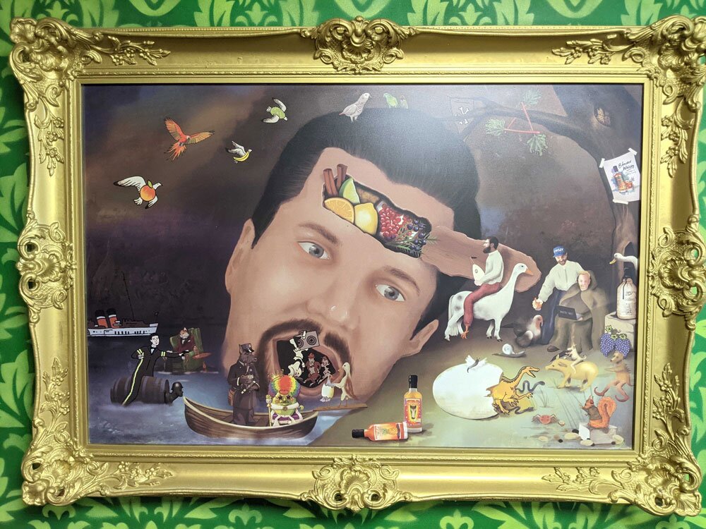 A framed painting of Ben Ellefson's head with whisky and flavour ideas pouring out
