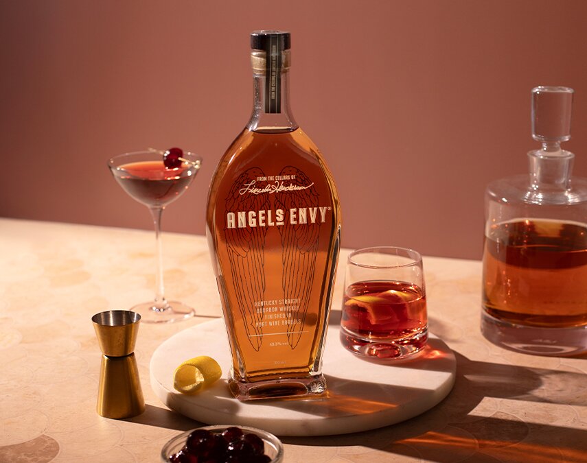 A bottle of Angel's Envy with a Sazerac cocktail.