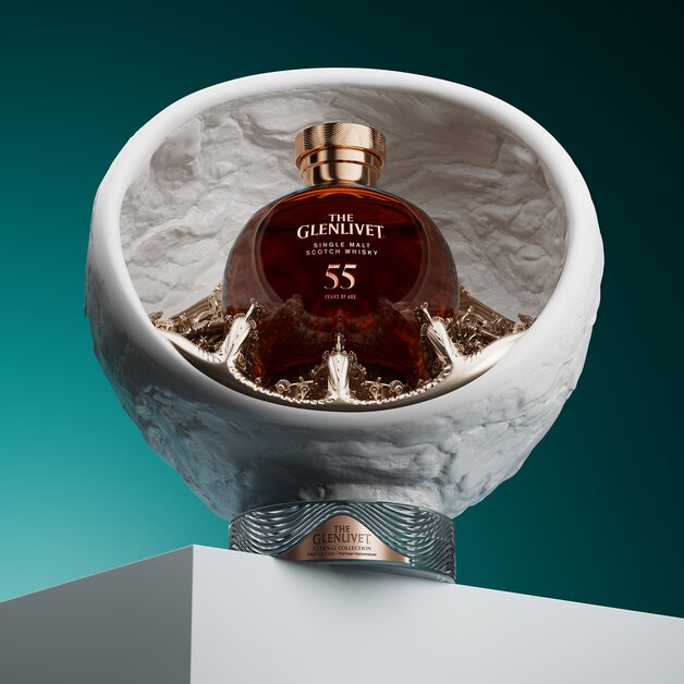 A bottle of the Glenlivet 55 Year Old next to its presentation stand.