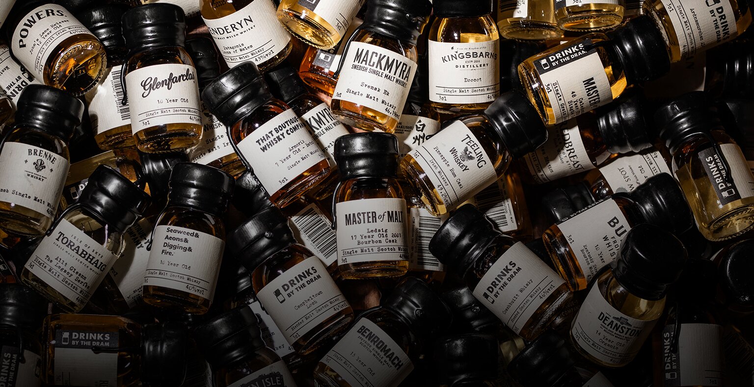 Loads of whisky drams in a pile. 