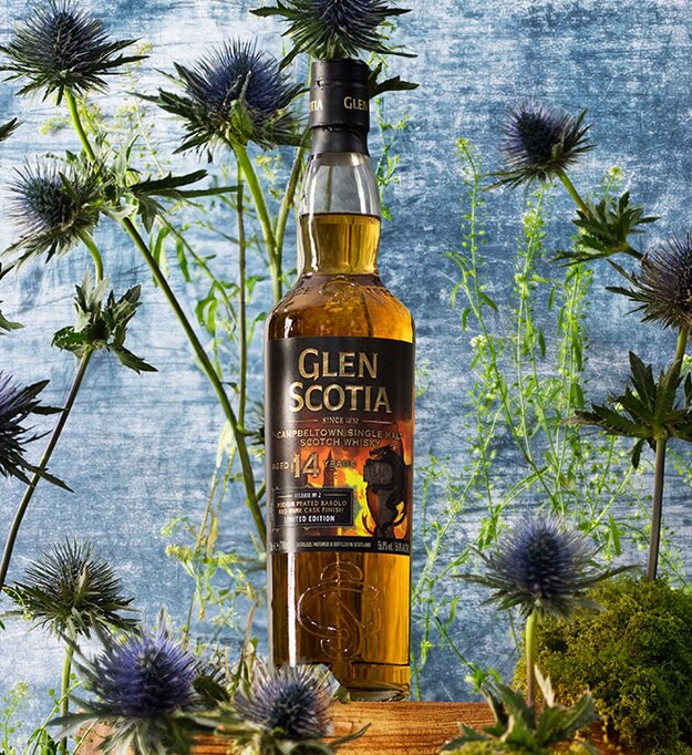 A bottle of The Glen Scotia 14 Year Old - Icons of Campbeltown Release No.2 surrounded by thistles. 